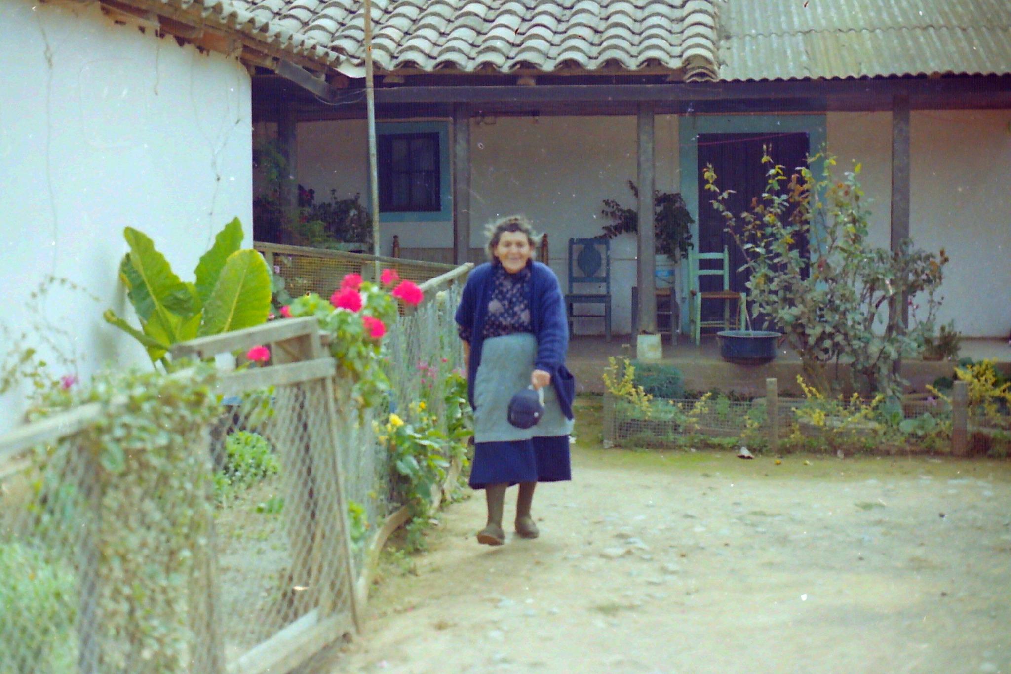 María Ramírez Bravo standing in front of her home